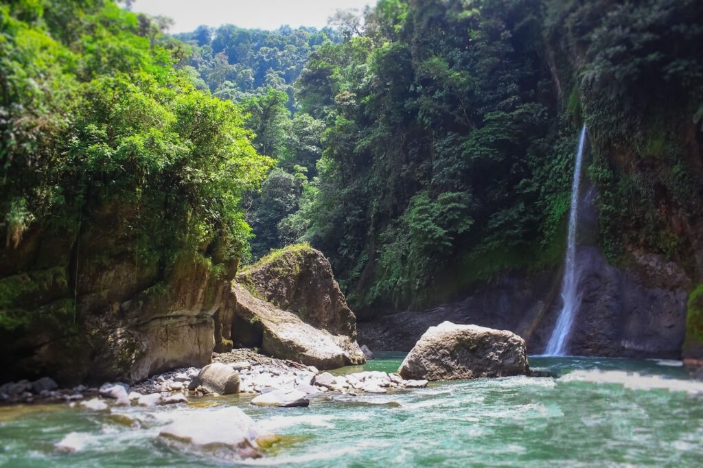 View of the Pacuare River with a waterfall in Costa Rica.