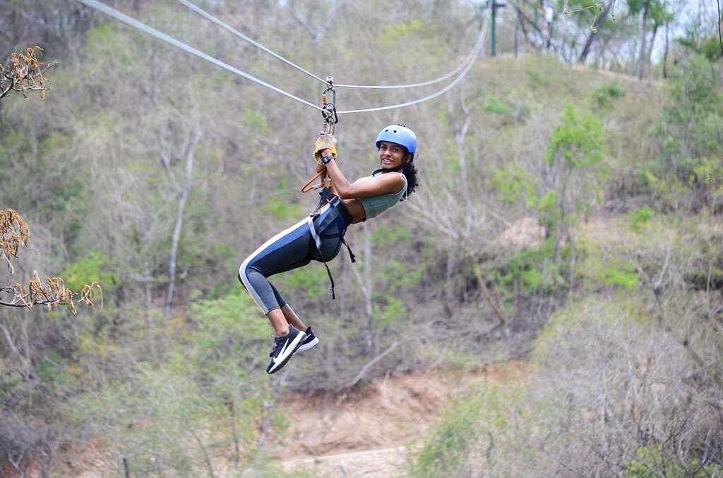 Person ziplining through a tropical forest during a Costa Rica canopy adventure tour.