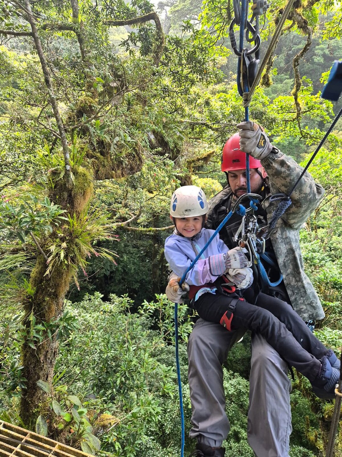 Child ziplining through Costa Rica’s lush forest canopy during a family-friendly canopy tour.